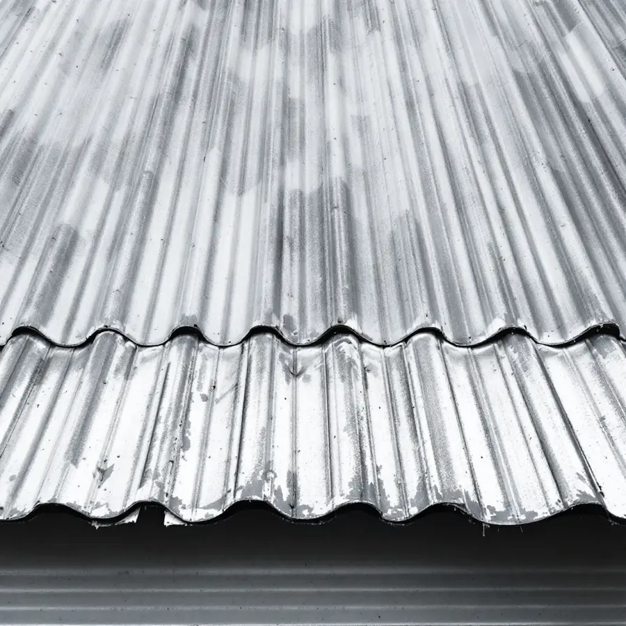 Weathered galvanised corrugated metal roofing with its characteristic wavy profile